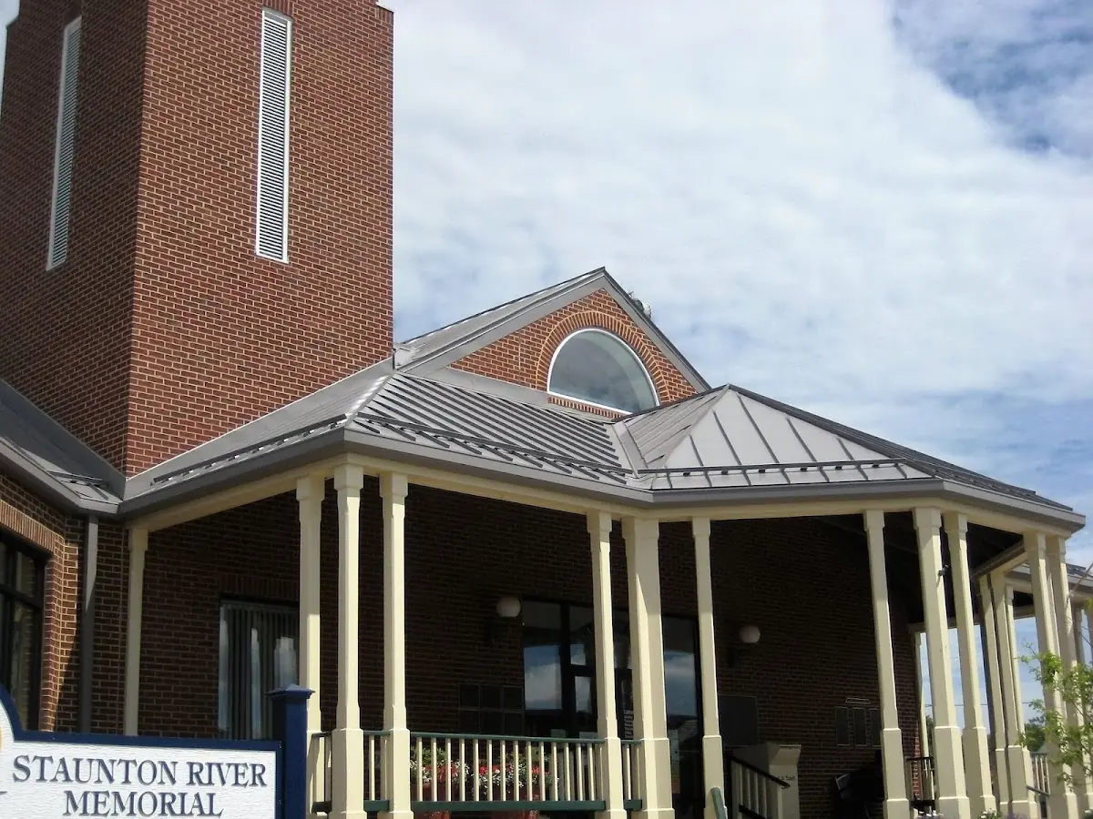 Skilled roofing craftsmen working on a residential roof in Big Rapids